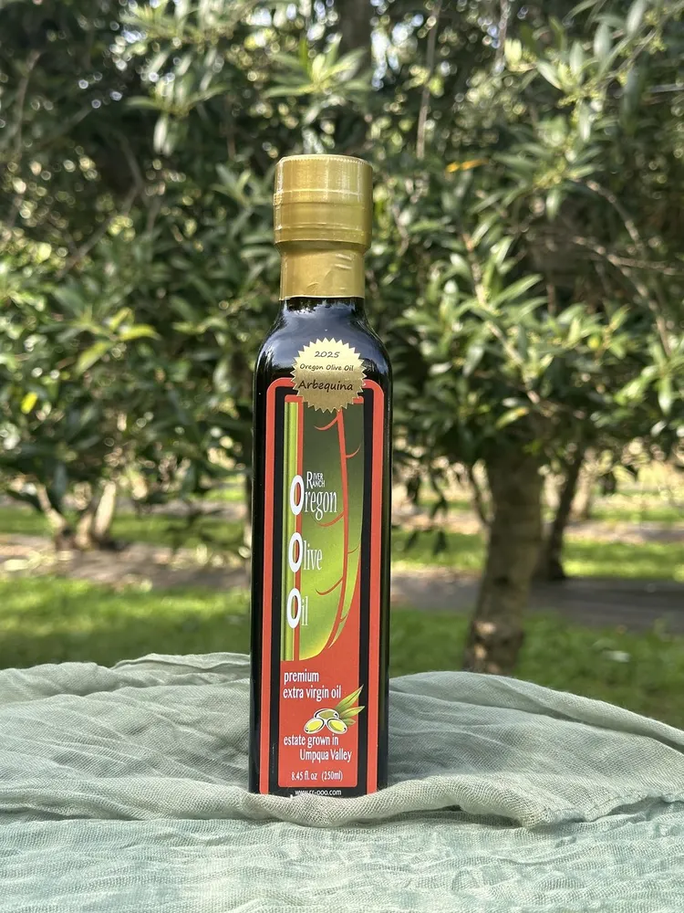 River Ranch 2025 Arbequina extra virgin olive oil bottle in its Oregon olive grove