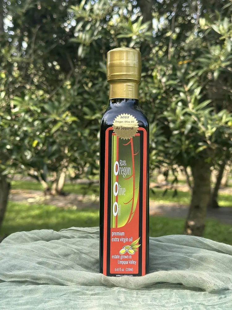 River Ranch 2025 Arbosana extra virgin olive oil bottle in its Oregon olive grove